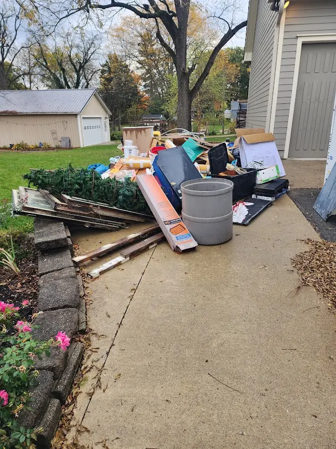 Dumpster being loaded with debris for Demolition Dumpster Rental in Pearl